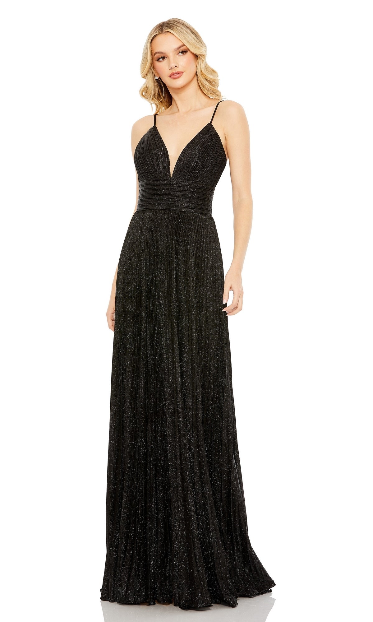 A woman in a floor-length, sleeveless Pleated Empire-Waist Long A-Line Prom Dress 30725 by Mac Duggal with thin straps and a deep V neckline stands against a white background.
